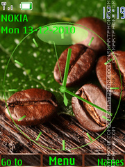 Coffee grains on a green leaf es el tema de pantalla